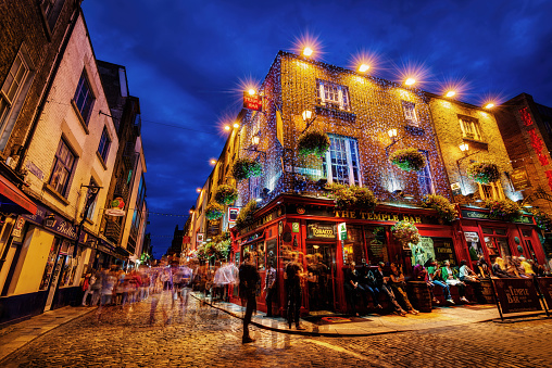A traditional Dublin pub lit up at dusk in Temple Bar